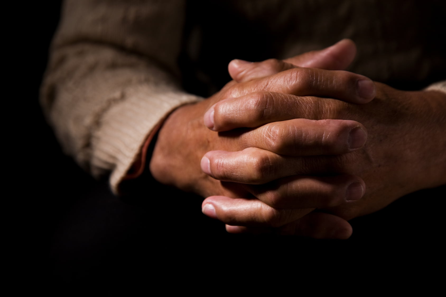 Black hands in prayer